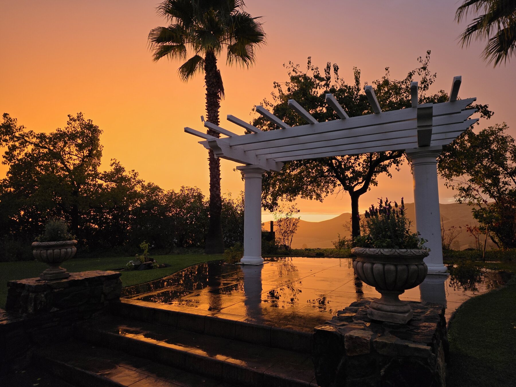The garden pavilion reflected in the pool at golden hour
